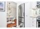 Modern kitchen with stainless steel refrigerator and dining area beyond, black and white floors and light fixtures at 1817 Jameston Dr, Charlotte, NC 28209