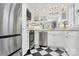 Well-equipped kitchen with stainless steel appliances, white cabinets, and checkered flooring with mirrored backsplash at 1817 Jameston Dr, Charlotte, NC 28209
