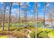 Lush backyard with a stone path leading to a serene lake at 19118 Betty Stough Rd, Cornelius, NC 28031