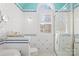 Bright bathroom featuring a tiled wall, glass shower, and arched window at 19118 Betty Stough Rd, Cornelius, NC 28031