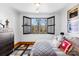 Bright bedroom featuring a large window with shutters and hardwood floors at 19118 Betty Stough Rd, Cornelius, NC 28031