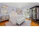 Charming bedroom with a decorative mirror, crystal chandelier, and hardwood floors at 19118 Betty Stough Rd, Cornelius, NC 28031