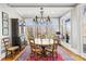 Charming dining area with a large window view of the lake, a round table, and an antique china cabinet at 19118 Betty Stough Rd, Cornelius, NC 28031