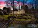 Elegant home with waterfront access, beautifully illuminated at twilight at 19118 Betty Stough Rd, Cornelius, NC 28031
