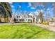 A charming white house with a red door and a large green lawn, perfect for outdoor activities and curb appeal at 19118 Betty Stough Rd, Cornelius, NC 28031