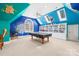 Colorful game room with custom murals, a billiard table, and built-in shelves at 19118 Betty Stough Rd, Cornelius, NC 28031