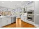 Bright white kitchen featuring stainless steel appliances, custom cabinets, large island, and an abundance of natural light at 19118 Betty Stough Rd, Cornelius, NC 28031