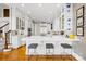 Modern kitchen featuring white cabinets, marble countertops, and stainless steel appliances, perfect for culinary enthusiasts at 19118 Betty Stough Rd, Cornelius, NC 28031