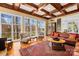 An elegant living room with hardwood floors, coffered ceilings, large windows with lake views, and wood detailing at 19118 Betty Stough Rd, Cornelius, NC 28031