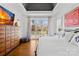 Bright and spacious main bedroom showcasing hardwood floors, a tray ceiling, and access to a private balcony at 19118 Betty Stough Rd, Cornelius, NC 28031