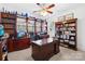 Spacious office with dark wood built-in shelving, a ceiling fan, and large windows at 19118 Betty Stough Rd, Cornelius, NC 28031