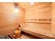 Inviting sauna with wooden benches and a traditional bucket and ladle for an authentic experience at 19118 Betty Stough Rd, Cornelius, NC 28031