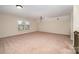 Upstairs bonus room featuring neutral carpet, windows with natural light, and ceiling fan at 2101 Darian Way, Waxhaw, NC 28173