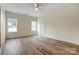 Bright and spacious bedroom with wood-look flooring and multiple windows at 2313 N Main St, Kannapolis, NC 28081