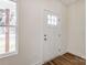 Bright entryway featuring a white door with glass panes and warm-toned wood floors at 2313 N Main St, Kannapolis, NC 28081