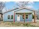Charming blue house with a covered front porch, offering a welcoming entrance and curb appeal at 2313 N Main St, Kannapolis, NC 28081