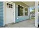 Inviting front porch with white columns and black railing accents at 2313 N Main St, Kannapolis, NC 28081
