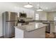 Modern kitchen with stainless steel appliances, white cabinets, and a granite countertop island at 2313 N Main St, Kannapolis, NC 28081