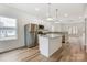 Open-concept kitchen with stainless steel appliances and an island with a granite countertop at 2313 N Main St, Kannapolis, NC 28081