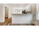 Modern kitchen featuring an island with bar seating, white cabinets, granite countertops, and stainless steel appliances at 2313 N Main St, Kannapolis, NC 28081