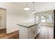 Bright kitchen featuring a granite countertop island and modern pendant lighting at 2313 N Main St, Kannapolis, NC 28081
