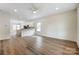 Open-concept living area with wood floors, seamlessly connecting to the kitchen and dining space at 2313 N Main St, Kannapolis, NC 28081