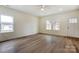 Sunlit living room with wood flooring and a view of the front yard, creating a warm and inviting space at 2313 N Main St, Kannapolis, NC 28081