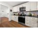 Modern kitchen featuring updated appliances and white cabinets with dark hardware at 2413 Hoffman St, Gastonia, NC 28054