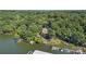 A beautiful aerial view of the waterfront property nestled amongst trees and the neighboring lake at 27056 Catamaran Dr, Tega Cay, SC 29708