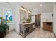 Bathroom featuring double vanity, wood framed mirrors, and barn door at 27056 Catamaran Dr, Tega Cay, SC 29708