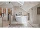 Bright bathroom featuring a freestanding tub, skylight, and tiled walls at 27056 Catamaran Dr, Tega Cay, SC 29708