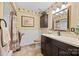 Bathroom with dark vanity, framed mirror, neutral tiling, and a shower with curtain at 27056 Catamaran Dr, Tega Cay, SC 29708