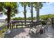 Lovely deck and lake view with outdoor seating surrounded by large trees and a view of the community marina at 27056 Catamaran Dr, Tega Cay, SC 29708
