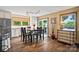 Dining area with wood floors, slider to backyard, and adjacent to the kitchen at 27056 Catamaran Dr, Tega Cay, SC 29708