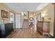 Open entryway features hardwood floors, staircase, and decorative accents creating a warm and inviting welcome at 27056 Catamaran Dr, Tega Cay, SC 29708