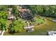 Aerial view of a lakeside property with a boat dock, multilevel decks, and landscaped yard; ideal for outdoor enjoyment at 27056 Catamaran Dr, Tega Cay, SC 29708