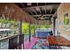 Covered outdoor patio with hot tub, wood finish, and tropical decor at 27056 Catamaran Dr, Tega Cay, SC 29708