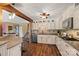 Well-lit kitchen featuring granite countertops, stainless steel appliances, and custom cabinets at 27056 Catamaran Dr, Tega Cay, SC 29708
