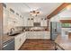 Well-lit kitchen with white cabinets, granite countertops, and stainless steel appliances offers style and functionality at 27056 Catamaran Dr, Tega Cay, SC 29708