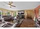 Spacious living room featuring a fireplace, hardwood floors, and large windows for natural light at 27056 Catamaran Dr, Tega Cay, SC 29708
