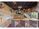 Enclosed tiki bar featuring a flat screen tv, wood finishes, and 3 barstools at 27056 Catamaran Dr, Tega Cay, SC 29708