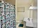 This bathroom features a floral shower curtain, white fixtures, and a clean design, perfect for a simple and functional space at 3010 Crosby Rd # 122, Charlotte, NC 28211