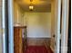 Entryway with wooden floors, a red rug and a wooden cabinet at 3010 Crosby Rd # 122, Charlotte, NC 28211