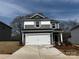 Charming two-story home with a two car garage and modern gray and white horizontal siding at 305 Alden Ct, Shelby, NC 28152