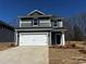 Charming two-story home featuring a two-car garage, stylish siding, and a well-maintained front yard at 311 Alden Ct, Shelby, NC 28152