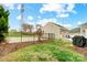 View of the backyard featuring basketball court, grill and small porch with chairs at 3350 Keady Mill Loop, Kannapolis, NC 28081