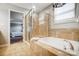 Bright bathroom featuring a glass shower, soaking tub, and neutral tile at 3350 Keady Mill Loop, Kannapolis, NC 28081