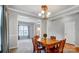 Spacious dining room features a chandelier and opens to the living room with neutral walls at 3350 Keady Mill Loop, Kannapolis, NC 28081