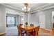 Dining room with classic wood table, chandelier, and neutral walls is ideal for entertaining at 3350 Keady Mill Loop, Kannapolis, NC 28081
