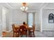 Traditional dining room with wood table set, chandelier, and neutral carpeting offers plenty of space at 3350 Keady Mill Loop, Kannapolis, NC 28081